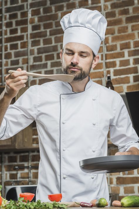 Portrait of male chef standing in kitchen tasting food Free Photo Chef Dress, Chef Pictures, Cooking Poster, Food Photography Background, Chef Styles, Cooking Photography, Man Cooking, Career Outfits, Chef Uniform