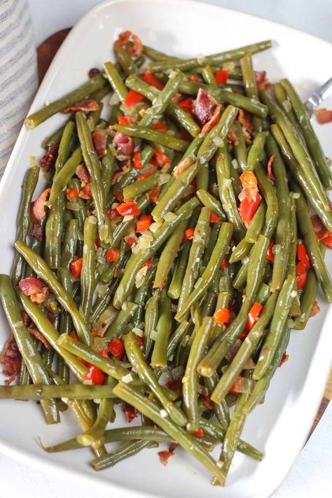 Elevate your side dish game with this mouthwatering Skillet Green Bean Recipe. These crisp-tender green beans are sautéed and steamed to perfection with the vibrant flavors of red bell pepper, onion, and garlic. Top it off with some crumbly bacon and you'll be coming back for seconds! Green Bean Recipes Skillet, Garlicky Green Beans, Skillet Green Beans, Pan Seared Pork Chops, Beans With Bacon, Seared Pork Chops, Green Beans With Bacon, Bean Recipe, Garlic Green Beans