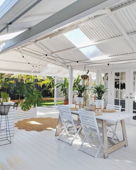 white paint brightens this once-dated alfresco entertaining area.   #alfrescoideas #gardenideas #patioideas #deckingideas #deckingdesign #renovation Woodlands Landscaping, White Decking, Harvest Dining Table, Bali Furniture, Poolside Decor, Timber Dining Table, Tropical Garden Design, Covered Pergola, Outdoor Entertaining Area