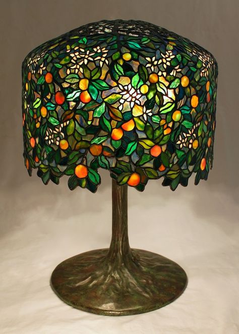 18″ Calamondin Orange Tree lamp. The lamp is an original Century Studios lamp design by Bill Campbell (see the previous post for our design inspiration). The lamp was designed to utilize the Tiffany 18″ Wisteria crown and form, and is now in a private Midwest collection. With just under 2050 individual... Tiffany Stained Glass Lamps, Tiffany Glass Lamp, Tiffany Lamp Aesthetic, Wisteria Lamp, Calamondin Orange Tree, Fun Lamps, Interesting Lamps, Bill Campbell, Glass Trees