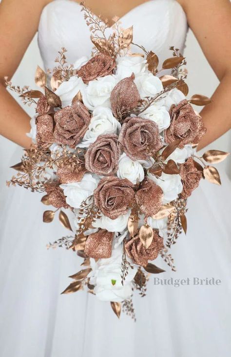 This is a cascading brides bouquet with white roses accented by rose gold glitter calla lilies, roses, and rose gold foliage. All of our wedding bouquets are made with artificial wedding flowers. Rose Gold Wedding Bridesmaids Dresses, Wedding Dresses With Rose Gold, White And Rose Gold Wedding Dress, Rose Gold Wedding Ideas Decor, Rose Gold And Brown Wedding Theme, Brown And Rose Gold Wedding, Rose And Brown Wedding, Rose Gold Wedding Nails For Bride, Rose Gold Wedding Dress The Bride