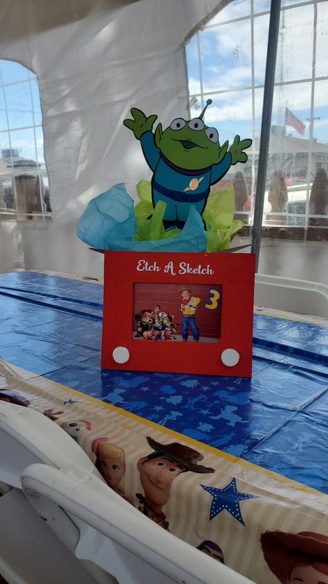 Toy Story 2nd Birthday Centerpieces, Toy Story Etch A Sketch Frame, Toys Story Centerpieces, Toy Story Gumball Centerpiece, Pixar Centerpieces, Toy Story Cake Table Ideas, Toy Story Table Decorations Centerpieces, Toy Story Birthday Centerpieces Diy, Toy Story Birthday Table Centerpieces