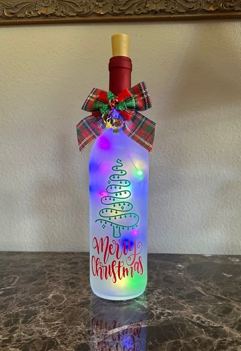 Get LIT by adding a wine bottle light to your Christmas decor! LED battery operated wine bottle lights. These make great gifts! Can also change the color of the neck, just leave a note when buying. The quote /message and Color on the bottle is standard but it can be personalized as you like with any name, quote of your choice. Just leave a note with purchase as to what you would like it to say. Colors may vary slightly due to computer monitor settings. Each order is handmade to order, actual pro Christmas Bottles Diy, Diy Christmas Wine Bottles, Wine Bottle Cricut Ideas, Christmas Wine Bottle Crafts, Painting Glass Bottles, Christmas Wine Bottle Crafts Diy, Holiday Wine Bottle Crafts, Christmas Lights Bottle, Glow Bottle