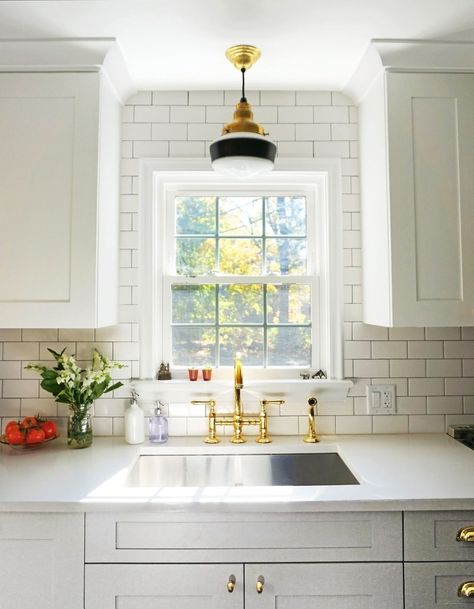 The sink in an AD editor's renovated kitchen | archdigest.com Kitchen Sink Lighting, Kitchen Credenza, Kitchen With White Cabinets, Renovated Kitchen, School House Lighting, Barn Light Electric, Over Sink, Classic Kitchen, Kitchen Trends