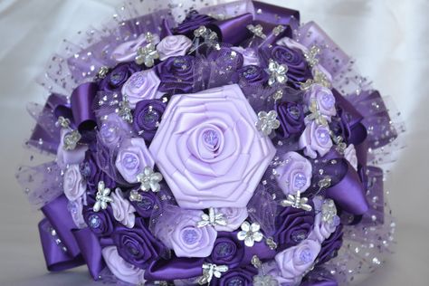 Celebrate your special day with this beautiful one of a kind purple bouquet! This piece is entirely made using purple and lavender satin. A gorgeous arrangement for those looking to match their purple colored theme/ dress, this bouquet will do! It is given some shine with clear crystals spread around the top and features tulle around as well. Every bit of this was entirely handmade. I know you will love it!  Thank you for looking!  I have been making wedding and bridal accessories for over forty Wedding Bouquet Purple, Pretty Bouquets, Butterfly Wedding Theme, Purple Quince, Wedding Vase Centerpieces, Bouquet Purple, Purple Bouquets, Purple Bouquet, Hand Bouquet