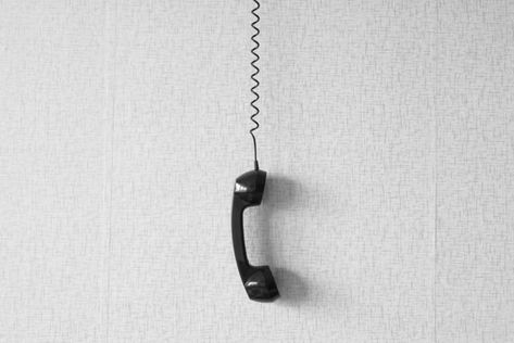 black old handset with a wire hang against wallpaper texture. black plastic telephone hanging by the cord.Retro Phone Cord - Vintage Telephone Handset Receiver hanging by the Cord down Numbers To Call, Wallpaper Texture, Phone Cords, Wall Phone, Vintage Phone, Minimal Photography, Doodle Icon, Vintage Phones, Retro Phone