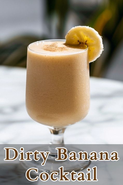 The Dirty Banana cocktail is a rich and creamy tropical drink that blends dark rum, banana liqueur, coffee liqueur, half-and-half, a very ripe banana, and ice. This cocktail combines the flavors of ripe banana, dark rum, and coffee, creating a sweet and indulgent beverage. Banana Rum Drinks, Dirty Banana Drink Recipe, Dark Rum Drinks, Banana Cocktail, Summer Rum Cocktails, Dark Rum Cocktails, Rum Cocktails Easy, Banana Cocktails, Banana Liqueur