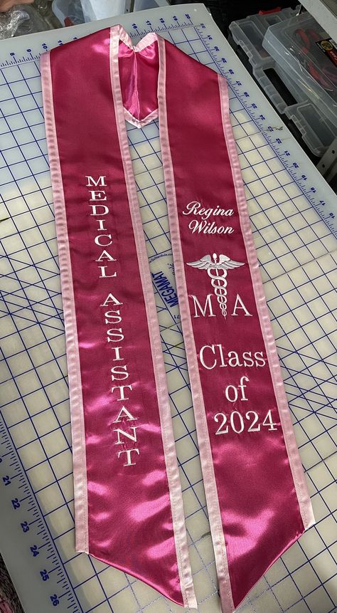 "Medical Assistant Graduation Stole Chiseled Stole personalized -Medical Assistant (Times Roman font) -Your Name (script font) -\"Medical Symbol MA\"      Use Pictures for reference, Will be just like pictures. - Class of 20XX (Script font) Write a note with  -Your Choice of Stole color - Your choice of edge color  -Your choice of thread color  Any additions will be an extra charge. -Message me for any particular color or any questions -Turn around time is 1 week production and 3-4 days for ship Graduation Caps Medical Assistant, Medical Assistant Graduation Sash, Med Assistant Aesthetic, Grad Stoles Ideas, Medical Assistant Job Duties, Medical Assistant Aesthetic Pink, Ma Week Ideas, College Stole Graduation Ideas, Pink Graduation Stole