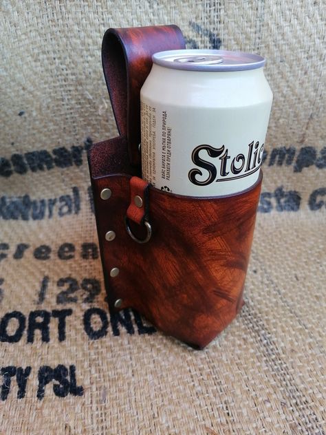 Introducing our handcrafted leather Bottle Holder - the perfect accessory for any summer outing! This unique beer holder is made entirely by hand from natural leather that has been hand-dyed, giving each piece a one-of-a-kind keto finish. Designed with convenience in mind, this bottle holder features a lifetime guarantee and ensures that your drink is always at your fingertips. Whether you're heading to summer festivals, competitions, concerts, or simply taking a stroll in the park, this versati Leather Bottle Holder, Beer Can Holder, Beer Holder, Beer Holders, Can Holder, Summer Festivals, Belt Leather, Can Holders, Bottle Bag