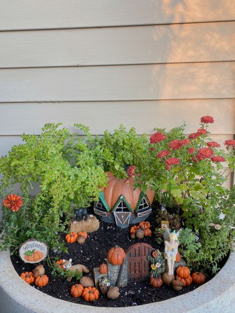 My favorite fall fairy garden 🧡 most of the items are found on Etsy ! tags - fall fairy garden, fairy garden, fairy house, first day of fall, fall garden, autumn flowers, secret garden, fairy miniature, miniature garden, red flowers, orange flowers, orange flower garden, mums, mum garden, mum miniature garden, fairy craft, diy fairy garden, garden ideas, diy garden, whimsical, garden art, easy fairy garden, easy minature garden, beginner fairy garden, fairy gardens, lush garden, pumpkin fairy g Autumn Fairy Garden Ideas, Fairy Garden Planter Boxes, How To Make A Fairy Garden Ideas, Raised Fairy Garden Ideas, Fall Fairy Garden Ideas, Outside Fairy Garden Ideas, Small Fairy Garden Ideas, Diy Halloween Fairy Garden, Mini Fairy Garden Ideas