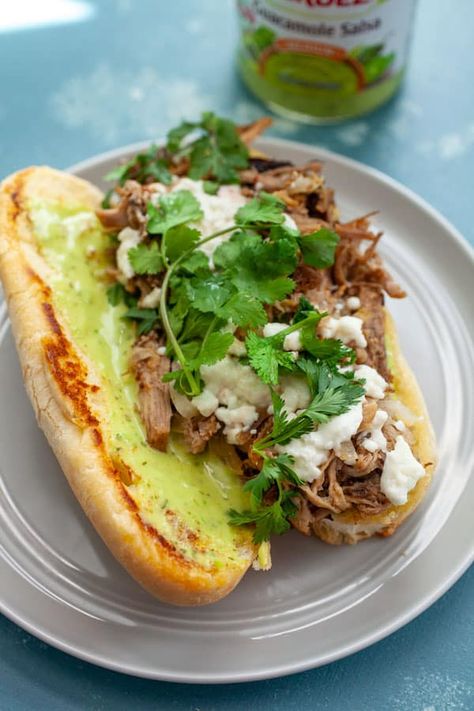 Have you had a Torta?!! It's a Mexican Sandwich that's usually filled with griddled meat, onions, and cheese, all stuffed in a soft roll. SO GOOD. I made this version with pressure cooker pulled pork and slathered it with Guacamole Salsa! macheesmo.com #tortas #pulledpork #sandwiches #mexican Mexican Food Tortas, Pork Tortas Sandwich, Carnitas Tortas Sandwich, Steak Tortas Sandwich Mexican, Bollios Mexican Sandwich, Torta Recipe Mexican, Mexican Tortas Sandwich Recipes, Mexican Sandwich Recipe, Mexican Tortas Sandwich