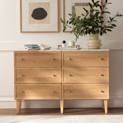 Upgrade your storage space and add a touch of elegance to your bedroom with our 6 Drawer Dresser. Its clean lines and neutral tones bring traditional style and natural warmth to any room. The quick and easy assembly process, sturdy engineered wood construction, and metal glides with safety stops make it a durable and practical choice for your busy lifestyle. Complete with sleek gold handles, this dresser is the perfect solution for all your storage needs. | Winston Porter Sivan 6 - Drawer Dresse Dressers Small Bedroom, Minimalist Bedroom Wood Furniture, Small Bedroom Drawers Ideas, Light Wooden Dresser, Light Wood Dressers, Dresser Under Window Bedroom, Japandi Dresser Bedroom, Ikea Björksnäs Dresser, Modern Organic Dresser