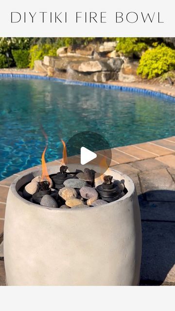 Janine Graff on Instagram: "DIY Tiki Fire Bowl🔥Transform your backyard into a high-end resort with this chic and easy project. Elevate your outdoor space with island vibes, turning an ordinary planter into a luxurious fire feature in no time and keep the bugs away.   For years, I dreamed of incorporating fire features into our backyard pool design but hesitated due to the expense and effort required for installation. Now, I absolutely love my DIY fire bowls because they offer the perfect solution: they’re affordable, easy to install, and create the ambiance I’ve always wanted without the hefty price tag or extensive labor. Even better? I made them myself!   To shop, comment LINK and I’ll message you same + similar details for decor and fashion.   Materials: * Resin planters * Mulch * Tiki Diy Fire Feature Outdoor, Diy Fire Bowls Outdoor Pool, Diy Fire Bowl, Janine Graff, Columbia House, Backyard Pool Design, Resin Planters, Fire Features, Pool Design