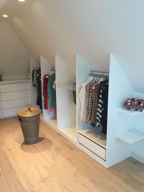 a simple and small Scandinavian attic closet with a dresser and open storage compartments that built into the attic nook Small Attic Spaces, Scandinavian Attic, Attic Storage Ideas, Attic Nook, Attic Bedroom Storage, Attic Wardrobe, Bedroom Built In Wardrobe, Attic Bedroom Designs, Attic Closet