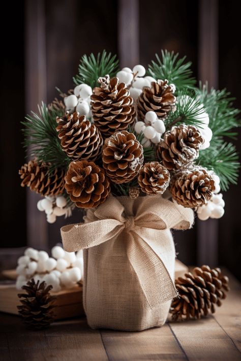 These rustic bunches look stellar with simple ceramic dishes; imagine a canvas of white, where your centerpiece paints the color. #Christmas #Holidays #HomeDecor Christmas Pine Cone Decorations, Simple Rustic Christmas Decor, Rustic Christmas Crafts, Christmas Crafts Diy Gifts, Pine Cone Christmas Decorations, Burlap Ornaments, Diy Natal, Crazy Laura, Christmas Decorations Centerpiece