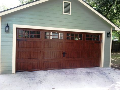 Clopay Gallery Collection grooved panel steel garage door with Ultra-Grain finish. Long panel design with long square windows. Looks like wood without the upkeep. Love how the warmth of the stain color looks against the pale green and creme paint color combo. Brown Garage Doors, Brown Garage Door, Faux Wood Garage Door, Garage Door Colors, Carriage House Garage Doors, Metal Garage Doors, Garage Door House, Garage Door Paint, Garage Door Windows