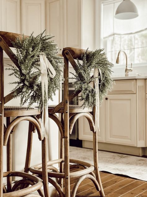 Christmas Chairs Decor, Wreaths For Chair Backs, Back Of Chair Wreath, Christmas Wreath Dining Chairs, Bar Stool Wreaths, Chair Decorations Christmas, Christmas Wreaths On Chair Backs, Dining Chair Christmas Decor, Back Of Chair Christmas Decor