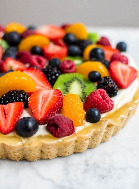 Whether you need a dessert recipe for a summer bash or a morning bridal shower, this gluten-free fruit tart with lemon curd is a definite show stopper. A buttery gluten-free shortbread crust, filled with silky lemon curd and an apricot lemon cream cheese filling, and topped with fresh fruit. Blueberries, strawberries, raspberries, blackberries, mandarin oranges and kiwi. Bright and fresh flavors with a variety of colors and textures. #glutenfree #summer #easy #entertaining Gluten Free Fruit Tart, Gluten Free Shortbread, Cake Light, Summer Bash, Mandarin Oranges, Fruit Toppings, Shower Desserts, Appetizer Ideas, Gluten Free Flour Blend