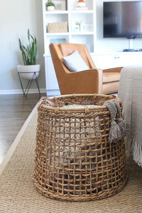 We love using baskets to corral all of the blankets in the living room. This is much better than having them all thrown around on the couch. Here's how to style throw blankets in your living room #throwblankets #throw #pillows #blanket #livingroom #livingroomstyle #diyplaybook Throw Blankets In Basket Living Rooms, Living Room Couch Throw Blanket, Couch Blanket Storage, Throw Blanket Organization, Blanket Basket Living Room, Throw Storage Living Rooms, Storage For Blankets In Living Room, How To Display Blankets, Throw Blanket Storage Living Rooms