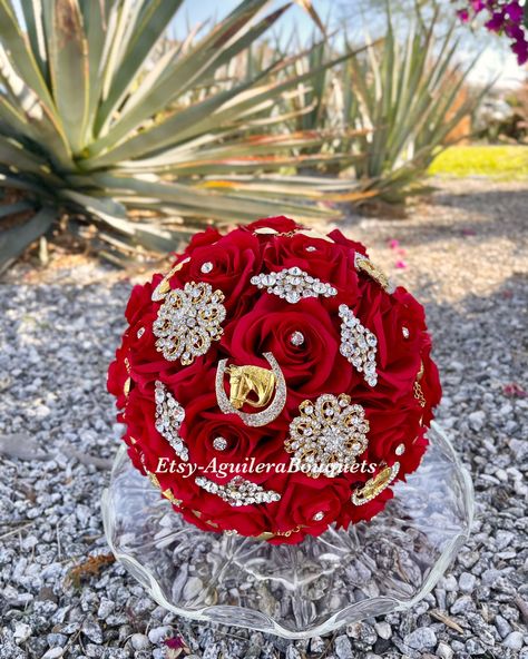 A beautiful charro themed bouquet for your special occasion. This bouquet is handmade to order with red silk roses, gorgeous sparkling gold brooches and rhinestones. We can do it in different colors. Please select the color of your choice. Please message me if you would like silver brooches instead.  *This bouquet is 10 inches in diameter* Please contact me with any questions! :) White Quince Bouquet, Quince Bouquet Red, Red Quince Bouquet, Black Quinceanera Theme, Red Quince Theme, Gold Quinceanera Theme, Quince Bouquet, Charro Theme, Red Quinceanera Ideas