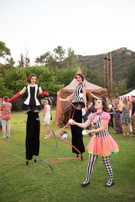 Circus Entertainment at Wedding    Photography: Lucy Munoz Photography   Read More:  http://www.insideweddings.com/weddings/cj-perry-and-miroslav-barnyashev/961/ Circus Theme Wedding, Alternative Wedding Reception, Fun Wedding Entertainment, Circus Wedding Theme, Circus Entertainment, Wedding Entertainment Ideas, Stilt Walker, Engagement Party Games, Cj Perry