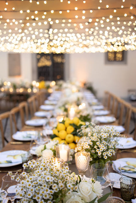 The floral arrangements by Deep Flowers were a combination of daisies and lemon-colored accents, representing simplicity and brightness. The white and green daisies were the epitome of purity, while the lemony hues added a sense of freshness and enthusiasm to the entire event. Wedding Yellow And Green, Chamomile Wedding Decor, Daisy Table Decorations, Lemon Wedding Decor, Daisy Wedding Theme, Wedding Lemon, Lemon Themed Wedding, Yellow White Wedding, Lemon Table Decor