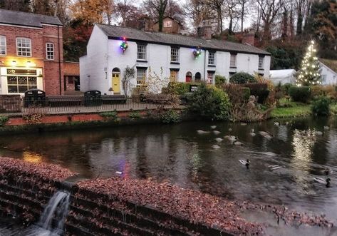 Lymm Village, Cheshire, UK, straddles the Bridgewater Canal and is surrounded by woods and meadows. The village features a waymarked heritage trail valley walk spanning about 3.5 miles taking in Lymm Dam, the Dingle, and the historic Slitten Gorge, home to 16th-century slitting mills. Bridgewater Canal, Cheshire Uk, 16th Century, The Village, House Styles