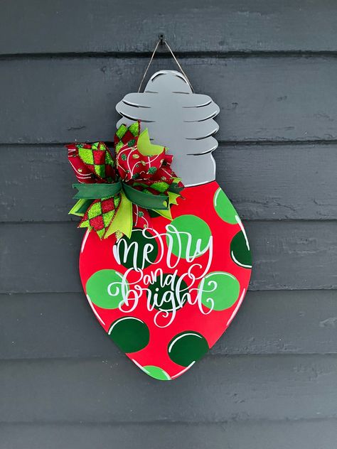 This door hanger is perfect to hang on your door all winter long. It has a cute little ribbon bow. The ribbon is high quality. It is hand painted and sealed. It is 19 inches long. It has traditional Christmas colors. It says merry and bright.  Comes in a sturdy box for storage.  Comes from a dog friendly home. Hobby Lobby Crafts, Wood Christmas Decorations, Door Hanger Christmas, Welcome Door Hanger, Decor Front Porch, Door Hangers Diy, Wooden Signs Diy, Door Signs Diy, Christmas Light Bulbs