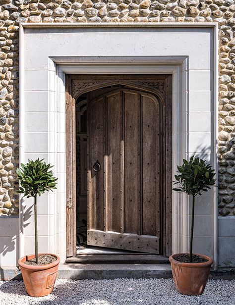 The front door is framed by a limestone surround reclaimed from a ruined 15th-century monastery Door Surrounds Interior, Cast Stone Front Door Surround, Limestone Door Surround, Stone Door Frame, Stone Door Surround, Front Door Surround, Wall Millwork, Clt House, Wonderland House