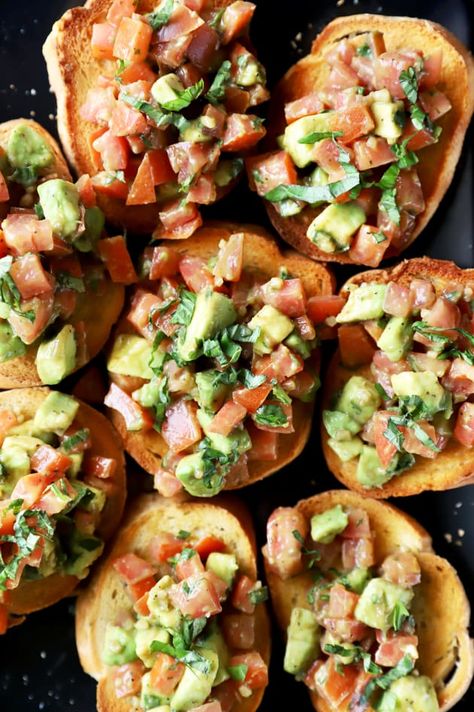 Avocado Bruschetta can be an elegant but easy way to start your dinner party. You'll love the addition of creamy avocado to the classic Italian appetizer. Italian Avocado Recipes, Bruschetta Recipe With Avocado, Avocado Crostini Appetizers, Avocado And Tomato Recipes, Avocado Toast Appetizer Party, Smashed Avocado Bruschetta, Avocado Bruchetta, Avocado Toast Appetizer, Mexican Bruschetta