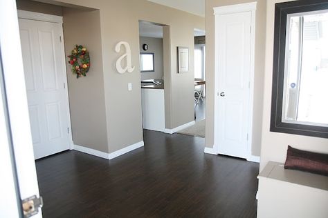 Dark wood floors, white trim and doors, wall color... Its all great! Wood Floors White Trim, White Trim And Doors, Trim And Doors, Dark Wood Trim, Upstairs Landing, Tan Walls, Living Room Wood Floor, Hardwood Floors Dark, Dark Floors