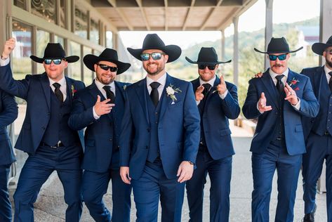 No Nashville wedding is complete without cowboy hats—here's your proof. This groom and groomsmen group had to take some personality pictures in their hats and glasses, these make for fun photos! | John Myers Photography & Videography Navy Blue Suit With Cowboy Boots, Farm Wedding Groomsmen, Groomsmen With Cowboy Hats, Suits And Cowboy Hats Wedding, Navy Blue Groomsmen Suits Cowboy Boots, Groomsmen Western Attire, Groom With Cowboy Hat, Groomsmen Cowboy Hats, Mexican Groomsmen Attire