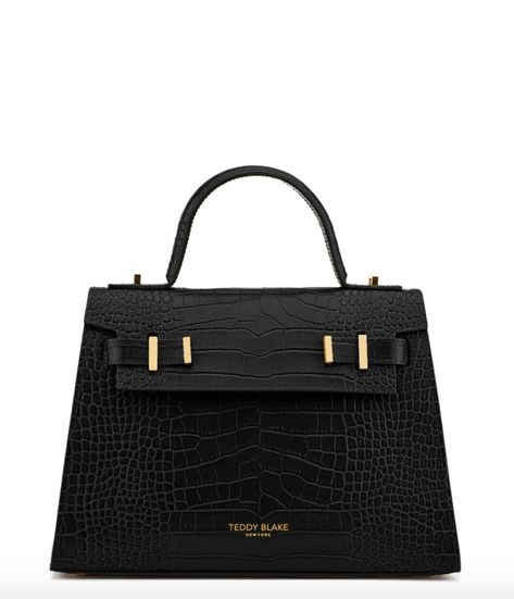 The New Ava by Teddy Blake signs a modern twist to an iconic chic design. Crafted by expert artisans in Italy with croco embossed calf skin. The style features a single round handle with a flap closure that opens to reveal a soft suede interior and well though compartmentalization with side pockets included. The Ava bag can take you from a ladies luncheon to an evening out without missing a beat when it comes to style and elegance.