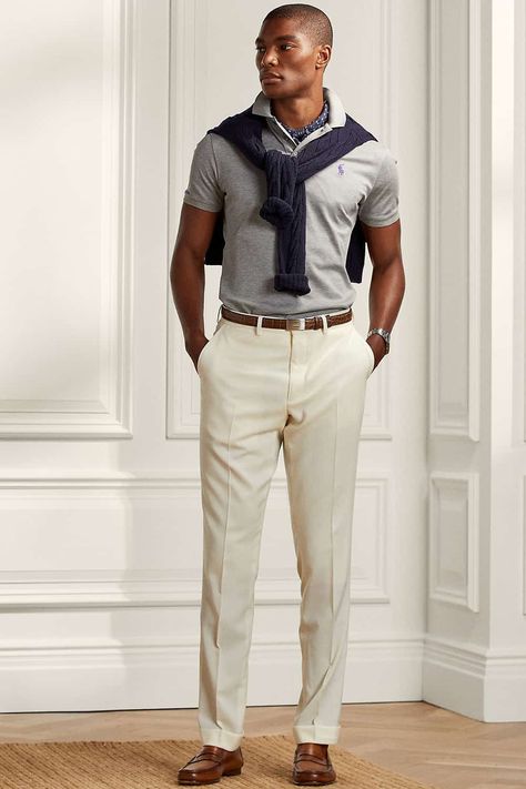 Men's beige pants, grey polo shirt navy sweater and brown leather loafers outfit. This outfit first appeared in the article: 20 Modern Preppy Outfits For Men: How To Get The Ivy League Look In 2022, on MensFlair.com Polo Tucked In Men, Gray Polo Outfit Men, Preppy Outfits For Men, Grey Polo Outfit Men, 80s Outfits For Men, Leather Loafers Outfit, Preppy Work Outfit, Preppy Outfits Men, Ivy League Look