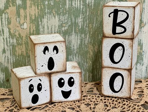 Cute Farmhouse Ghost decor for your rustic halloween. You can choose between one set of ghost blocks, one set of 'BOO" blocks or both sets together. Blocks measure 2"x2". Blocks are not attached. Blocks Painted white, sanded and distressed to add to it's farmhouse charm. Faces and letters are high quality vinyl.  NoteThis is a stock photo so pieces will vary slightly from original photos. Crafts With 4x4 Scraps, Halloween Wood Blocks Diy, Fence Picket Halloween Decor, Halloween Wood Block Crafts, Wood Fall Crafts To Sell, 4x4 Halloween Wood Crafts, Ghost Wood Crafts, Halloween Blocks Wooden, Small Wooden Blocks Craft Ideas