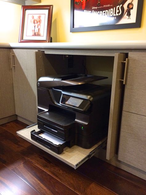 Printer hide - away!   Many of us are using our printers less these days and in a cozy home we generally do not want to see this large machinery out to clutter a fine designed home office. Pocket doors and sliding shelf makes for a neat hide-away for any printer or machine.  Created #HomeOffice by #Malka and #RCCabinetsandClosets of #Sonoma  #OfficePrinter #HomeOffice #InteriorDesign #ProfessionalOrganizer #ProfessionCabinetDesign #PrinterShelf #PrinterCabinet Office Printer Cabinet, Hide Printer In Office, Hiding Printer In Home Office, Large Printer Storage Ideas, Home Office With Printer, Office Pocket Doors, Printer Table Ideas, Hide Printer, Printer Storage Ideas