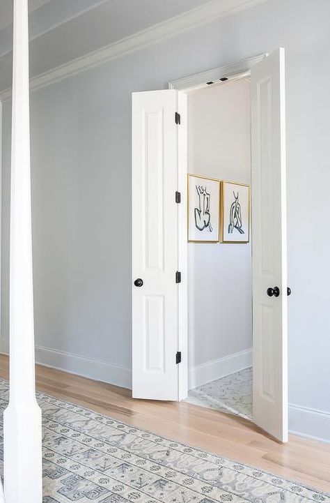 Master bath off bedroom boasts white bi-fold doors, blue walls and a gray vintage rug at entrance. Adding Door To Bathroom Master Bath, Toilet Room Door Master Bath, Mini Double Doors, Half Doors Ideas, Double Door Bathroom Master Bath, Alternate Bathroom Door Ideas, Bathroom Door Swing Out, 2 Door Bathroom Ideas, Petite Double Door Bathroom