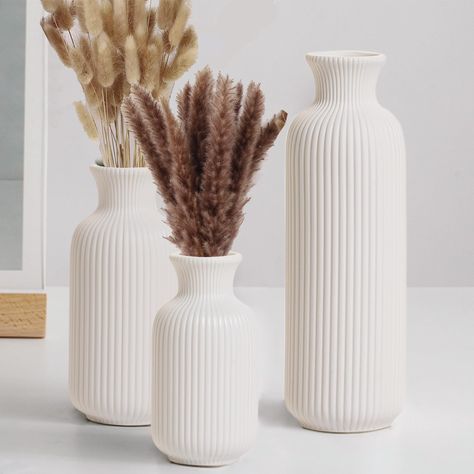 PRICES MAY VARY. 【Exquisite White Ceramic Vase】White ceramic vase set with ribbed design, with clean lines performance highlights the elegance and simplicity of the flower vase, suitable for placing in then place, is a great choice for home decor. 【High Quality Vases】White ceramic vase is made of 100% high quality clay, beautiful and smooth lines, white matte surface, thickened bottom design makes the center of gravity stable, not easy to tilt, durability, perfect for your living room, desktop, Pampas Vase Decor, Minimalistic Fall Decor Living Room, Beautiful Vases With Flowers, Minimal Table Centerpieces, Apartment Neutral Decor, Modern Living Room Accessories, Diy Ceramic Vase, Cali Bedroom, Self Decor