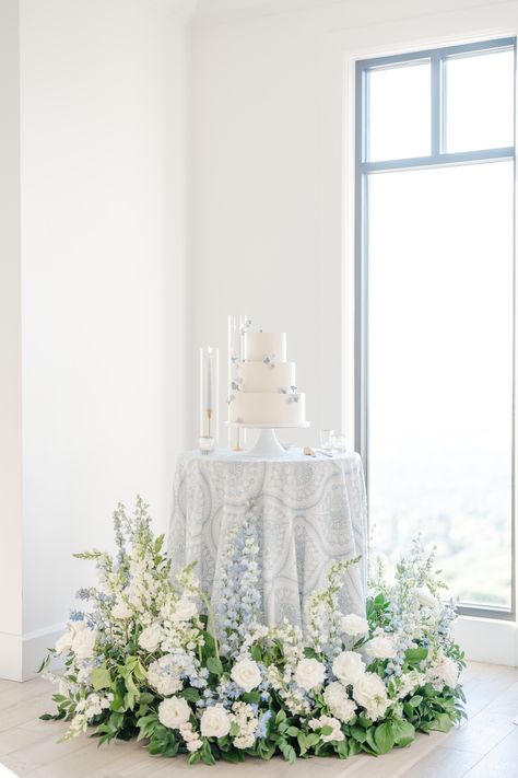 White Florals With Blue Accents, Summer Wedding White Flowers, Hydrangea Cloud Wedding, White Wedding Cake White Flowers, Dusty Blue Top Table Flowers, Blue And White Floral Wedding Cake, Powder Blue Theme Wedding, Dusty Blue Wedding Flowers Centerpieces, Dusty Blue Cake Table