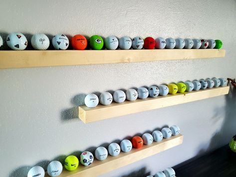 "Great way to display your collection of golf balls or even better gift for someone else! Each rack is made from reclaimed lumber that would have been thrown away before we rescued it. We cut each to size, drill out the holes, sand, finish and install easy to hang hardware. Each rack will come with wall anchors and screws to securely mount to any wall. Even better you will get a FREE golf ball with each rack ordered. (Golf balls may be new and or used)    We make four different sizes: 12\"- 6 Ba Golf Display, Golf Ball Display, Golf Ball Holder, Golf Ball Displays, Golf Room, Ball Display, Ball Holder, Reclaimed Lumber, Display Wall