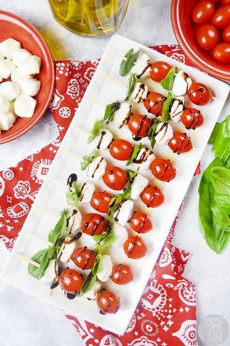 Caprese Salad Skewers are easy to serve and are always a crowd pleaser.  The flavors of tomato basil and mozzarella mingle together to make one perfect bite. #capreseskewers #caprese #capresesaladskewers #capreseskewersbalsamic #balsamic #basil #tomato #capresesalad #italian #appetizer #capreseappetizer #partybite #bitesized #saladskewer #party #recipe #partyappetizer #easyappetizer Mozerella And Tomato Skewers, Mozerella Tomato Caprese, Tomato Mozzarella Skewers, Mozzarella Tomato Basil, Caprese Recipe, Tomato Skewers, Caprese Appetizer, Salad Skewers, Caprese Salad Skewers