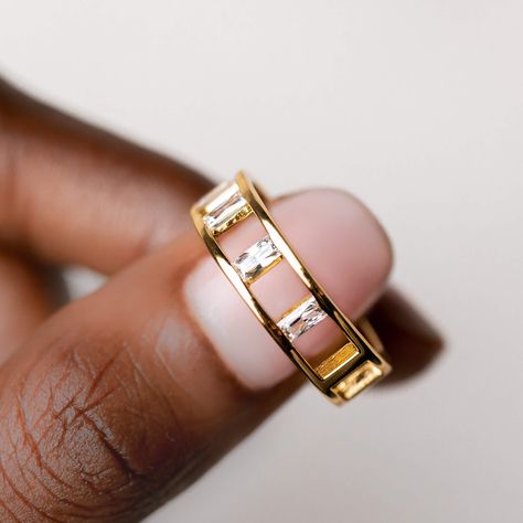 A unique gold ring with geometric cutouts and baguette cut gemstones. This negative space ring can be worn as a statement piece or stacked with other rings for an intricate and detailed look.  Made with 4 cubic zirconia gemstones, each measuring at 2mm.  Size: 5, 6, 7, 8, 9 Space Ring, Unique Gold Rings, Space Rings, Unique Silver Rings, Unique Wedding Band, Ring Inspo, Baguette Diamond Rings, Baguette Ring, Big Rings