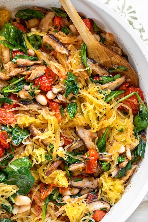 Roasted spaghetti squash is sauteed with garlicky veggies and white beans for this cozy, fall-inspired vegetarian meal! | thecozyapron.com #spaghettisquash #spaghettisquashrecipes #spaghettisquashrecipeshealthy #spaghettisquashrecipeseasy #roastedspaghettisquash #spaghettisquashvegetarian #spaghettisquashhealthy Vegetarian Recipes Spaghetti Squash, Spaghetti Squash And Veggies Recipes, Spaghetti Squash Mediterranean Recipes, Stuffed Spaghetti Squash Vegetarian, Spaghetti Squash Vegetarian, Spaghetti Squash Recipes Vegetarian, Vegan Spaghetti Squash Recipes, Vegetarian Spaghetti Squash Recipes, Fall Squash Recipes