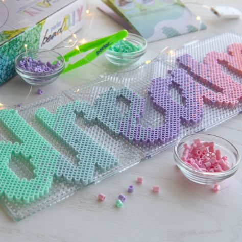 "Buy the Perler® Bead DIY Dream Light-Up Bead Art Kit at Michaels. Make a your own bedroom décor sign with this Perler bead DIY dream light-up bead art kit. Make a your own bedroom décor sign with this Perler bead DIY dream light-up bead art kit. Use the included Perler beads and pattern to spell out a pastel ombre, \"Dream,\" then wrap the letters in fairy lights, lean it up against the back of your desk or hang it on the wall. Turn on the lights to enjoy your cute DIY décor piece. Details: Inc Harry Potter Perler Beads, Melty Bead Designs, Pastel Ombre, Melty Bead Patterns, Pearl Beads Pattern, 3d Perler Bead, Bead Diy, Hama Beads Design, Perler Bead Templates