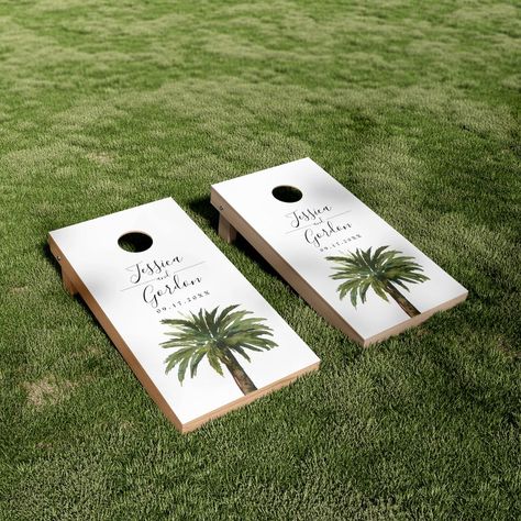 A unique palm tree-themed set of cornhole boards tailored specifically to your future wedding on the beautiful coast or island.  They feature a minimal style illustration of a single palm tree.  Above this rest the unique names of the bride and groom in an elegant cursive style font. Outside Beach Wedding, Island Themed Wedding, Wedding Reception Ideas Beach, Beach Ceremony Wedding, Classy Tropical Wedding, Coastal Beach Wedding, 30a Elopement, Tropical Wedding Theme Colors, Elegant Beach Wedding Decorations