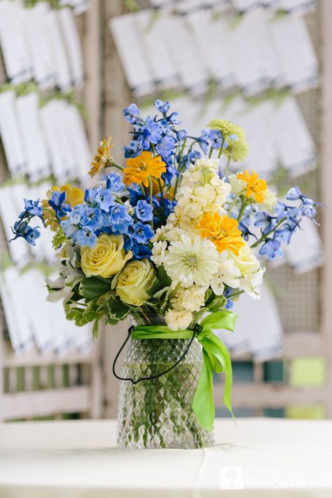 Something blue, with sunny yellow and bright greens. © Carolina Photosmith Styled by @Loluma Wedding Planning + Design Navy Blue And Yellow Flower Arrangements, Light Blue Yellow And Green Wedding, Blue Yellow Centerpieces, Yellow And Periwinkle Wedding, Blue White Yellow Flower Arrangements, Blue Yellow Green Flower Arrangements, Blue Yellow And White Flower Centerpieces, Blue And Yellow Wildflower Wedding, Blue And Yellow Flower Centerpieces