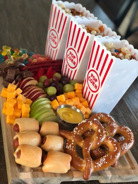 A spread of concession stand favorites family movie night Movie Night Snack Board, Family Movie Night Snacks, Concession Stand Food, Dinner Ideas For Family, Movie Night Dinner, Movie Night For Kids, Movie Night Food, Movie Night Birthday Party, Christmas Movie Night