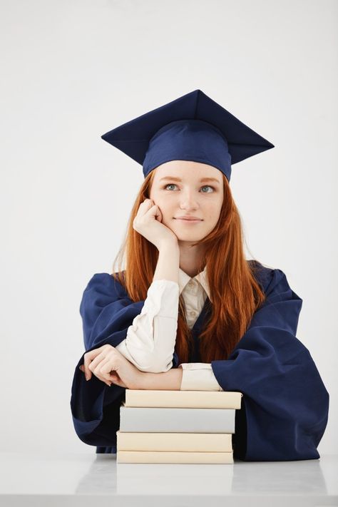 Dreamy graduate woman smiling thinking sitting with books over white surface Free Photo Successful Student Photo, Graduation Photoshoot With Books, Education Graduate Pictures, Graduate Studio Photoshoot, Grad Photos With Books, Graduation Pictures Indoor, Graduation Shoot Studio, Graduation Photos Studio, Studio Graduation Photos