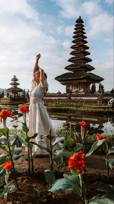 A young woman standing next to Pura Ulun Danu Beratan, a temple on a lake in Bali, Indonesia at sunrise Munduk Bali, North Bali, Bali Travel Photography, Visit Bali, Thailand Pictures, Bali Waterfalls, Temple Bali, Bali Baby, Water Temple