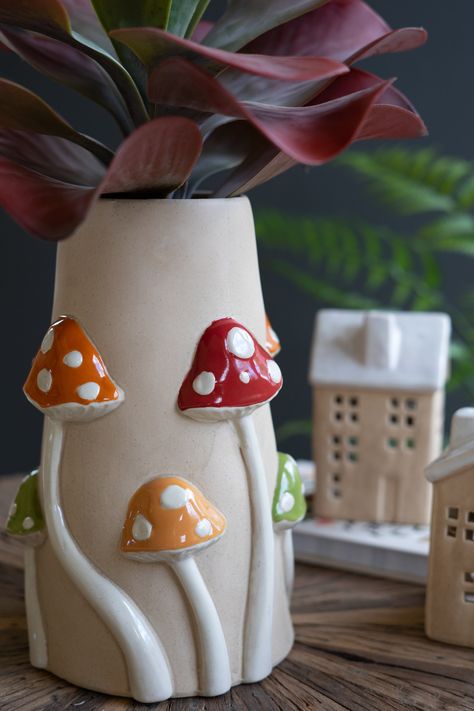 Display your blooms or botanicals in natural style. Toadstools in red, green, and yellow climb this 3D ceramic mushroom vase. Use it for kitchen utensils, year-round arrangements, or corner decor. Imported Brand: Kalalou Mushroom Vase, 3d Ceramic, Ceramic Mushroom, Coil Pottery, Coil Pots, Corner Decor, Clay Vase, Mushroom Decor, Pottery Crafts